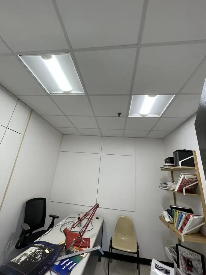 Office restored after a flood with new drop ceiling, lighting and painted walls