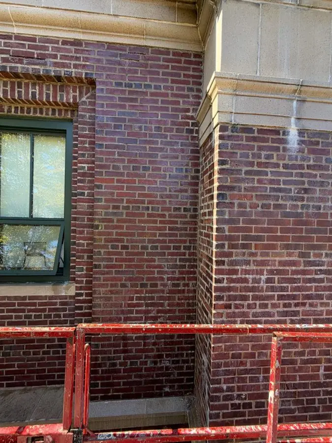 Upper-story brick facade sealed and waterproofed, worked from a lift