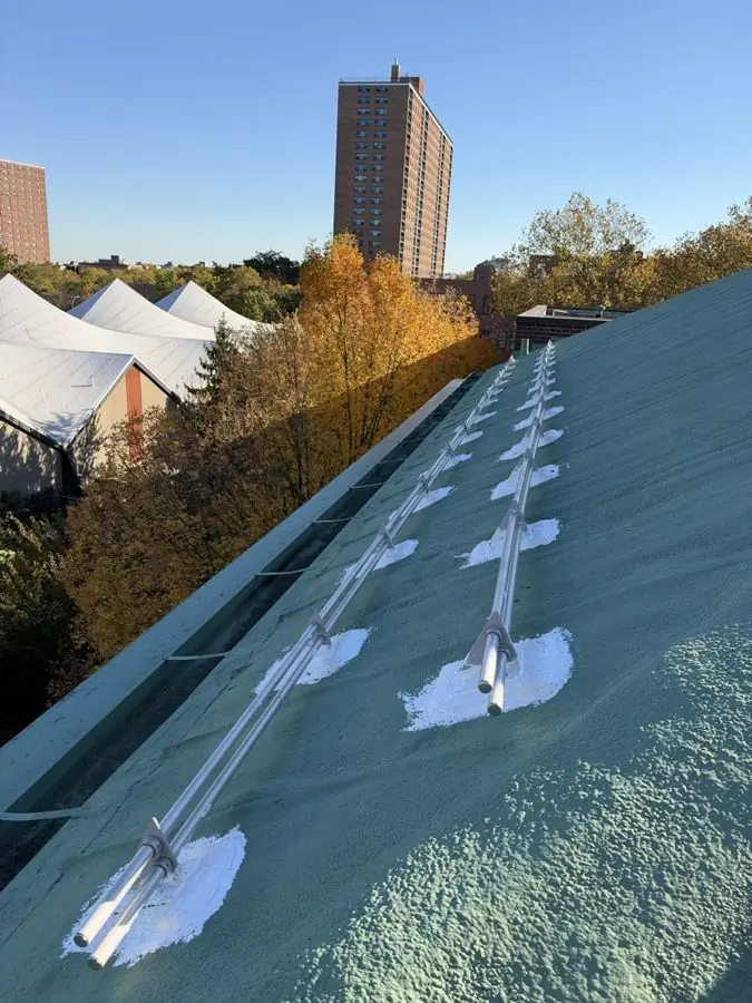 Coated metal roof with every snow guard bracket sealed against leaks
